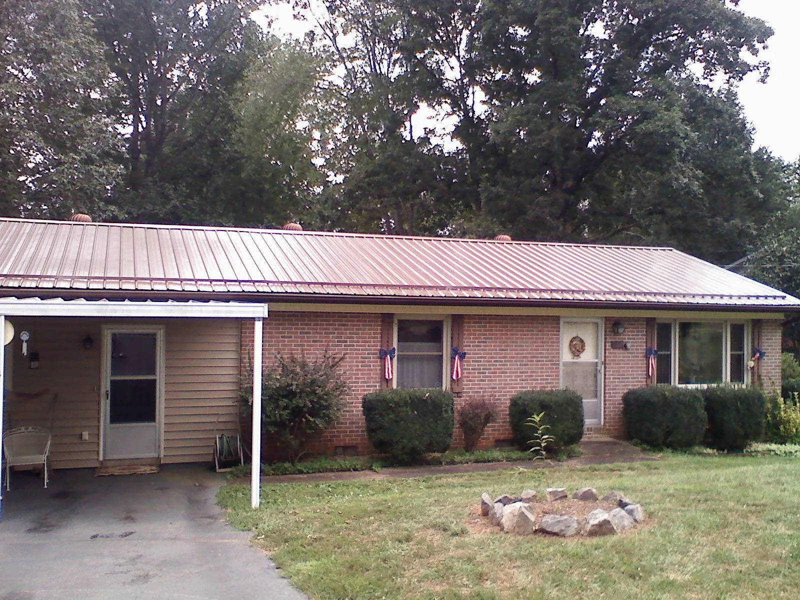 Bronze metal roof and carport on a brick ranch home — Roof Repair work by our crew in Glen Ellyn